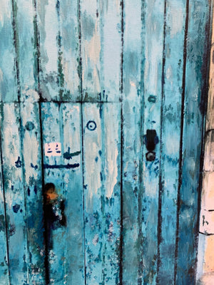
                  
                    Close up of sea-wear wooded doors and slight rust on metal door handles. 
                  
                